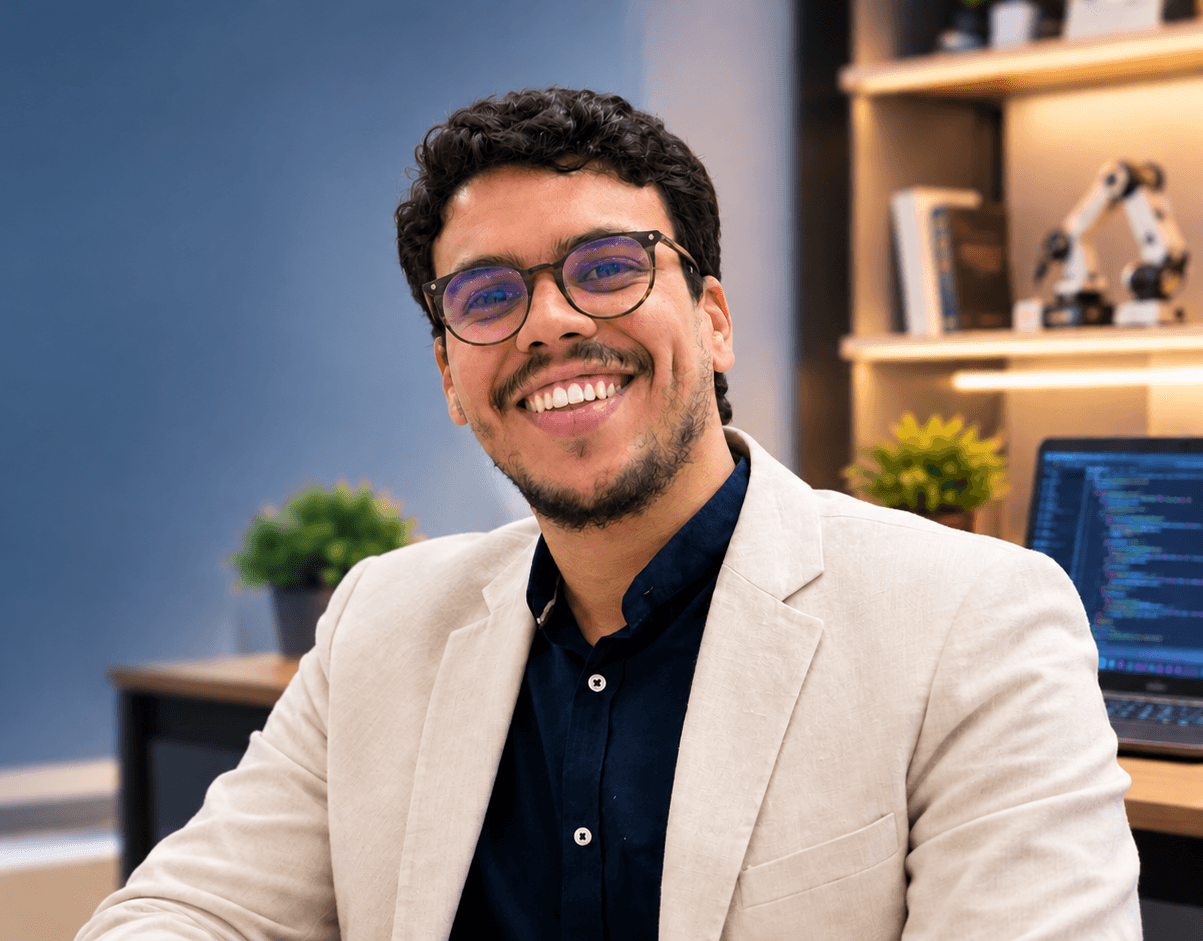 Abdelmoemen Trabelsi, smiling at his desk with a laptop